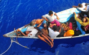 090525-N-4774B-032  GULF OF ADEN (May 24, 2009) Somali migrants in a disabled skiff wait for assistance from Sailors aboard the guided-missile cruiser USS Lake Champlain (CG 57). The skiff, originally ferrying 52 passengers, was spotted in distress by helicopter pilots assigned to the "Wolfpack" of Helicopter Anti-Submarine Squadron Light (HSL) 45 while patrolling the area. Lake Champlain is deployed as part of the Boxer Expeditionary Strike Group supporting maritime security operations in the U.S. 5th Fleet area of responsibility. (U.S. Navy photo by Mass Communication Specialist 2nd Class Daniel Barker/Released)